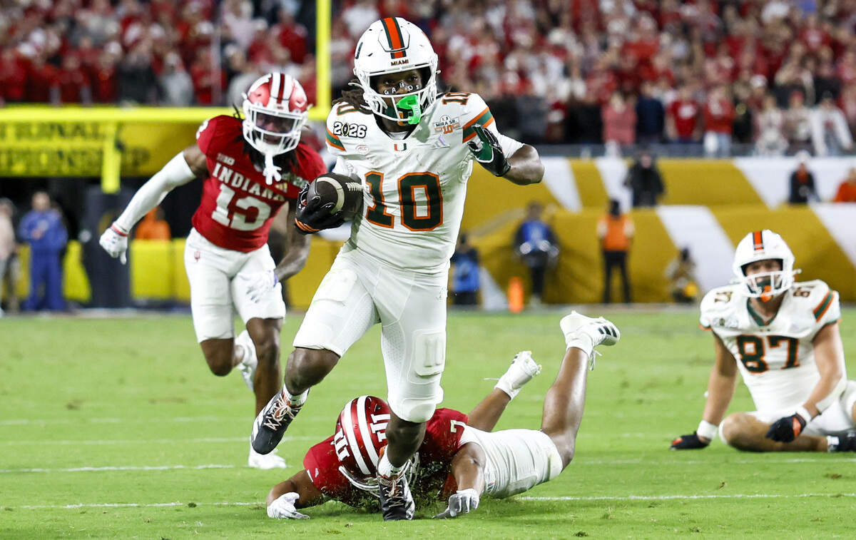 Miami Hurricanes wide receiver Malachi Toney (10) breaks a tackle to score against the Indiana Hoosiers in the second half of the College Football Playoff National Championship Game at Hard Rock Stadium in Miami Gardens, Florida, on Monday, January 19, 2026.